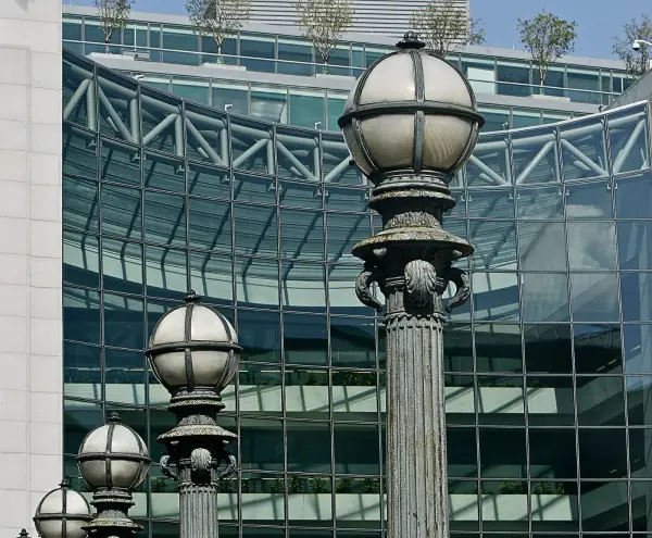 Ornate street lamps in front of the glass facade of SEC headquarters in Washington