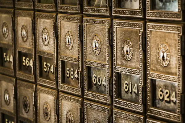 Numbered metal safe deposit boxes in a bank vault