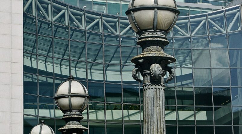 Ornate street lamps in front of the glass facade of SEC headquarters in Washington