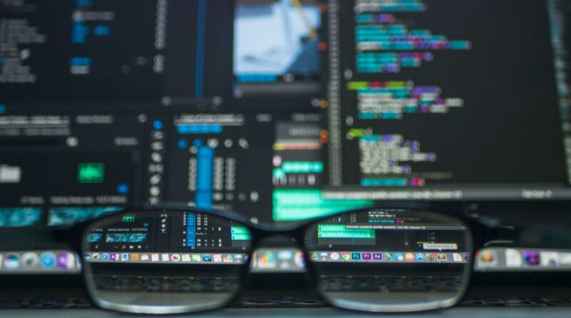 Eyeglasses in front of a laptop screen full of code